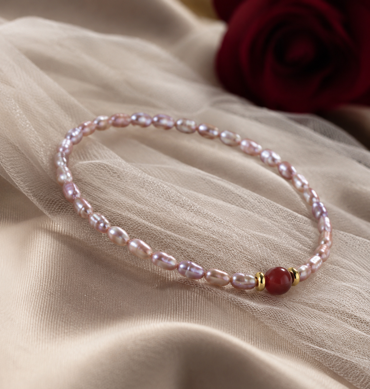 4 to 5 mm pink rice shaped freshwater pearl bracelet with a polished red center stone