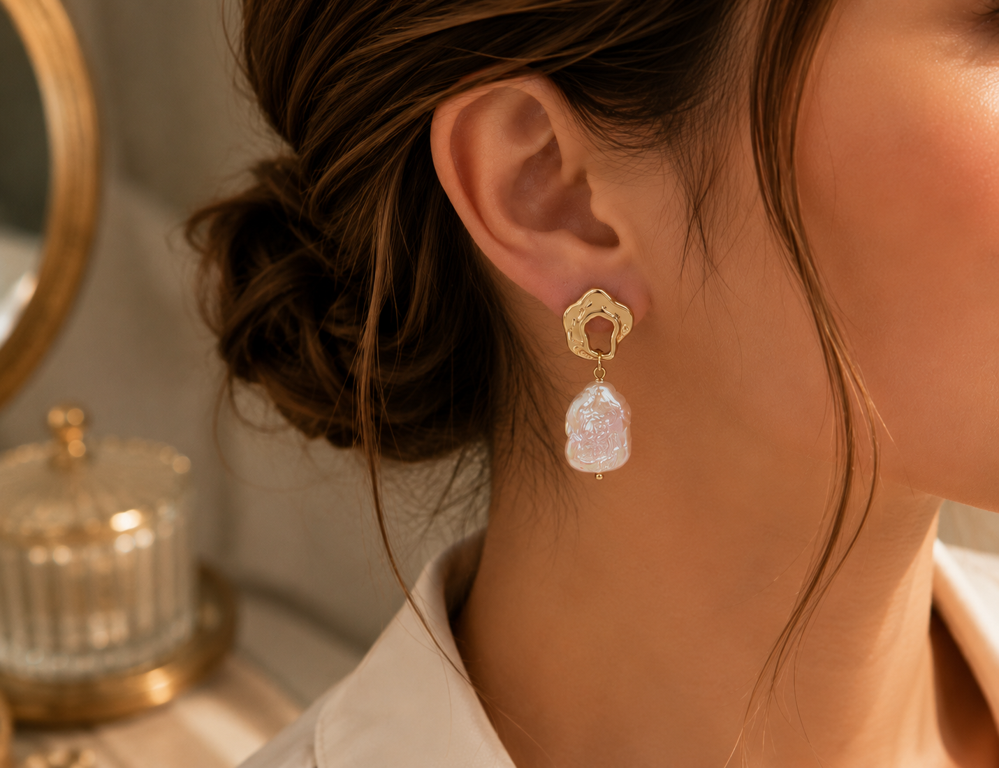 Right-side view of woman wearing freshwater baroque pearl drop earrings