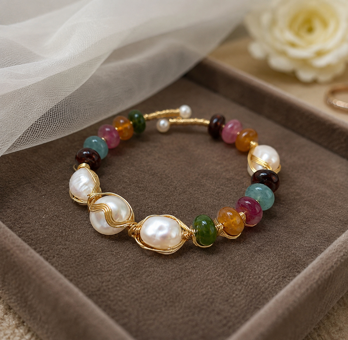 White baroque freshwater pearl bracelet with colorful beads displayed on a brown jewelry box