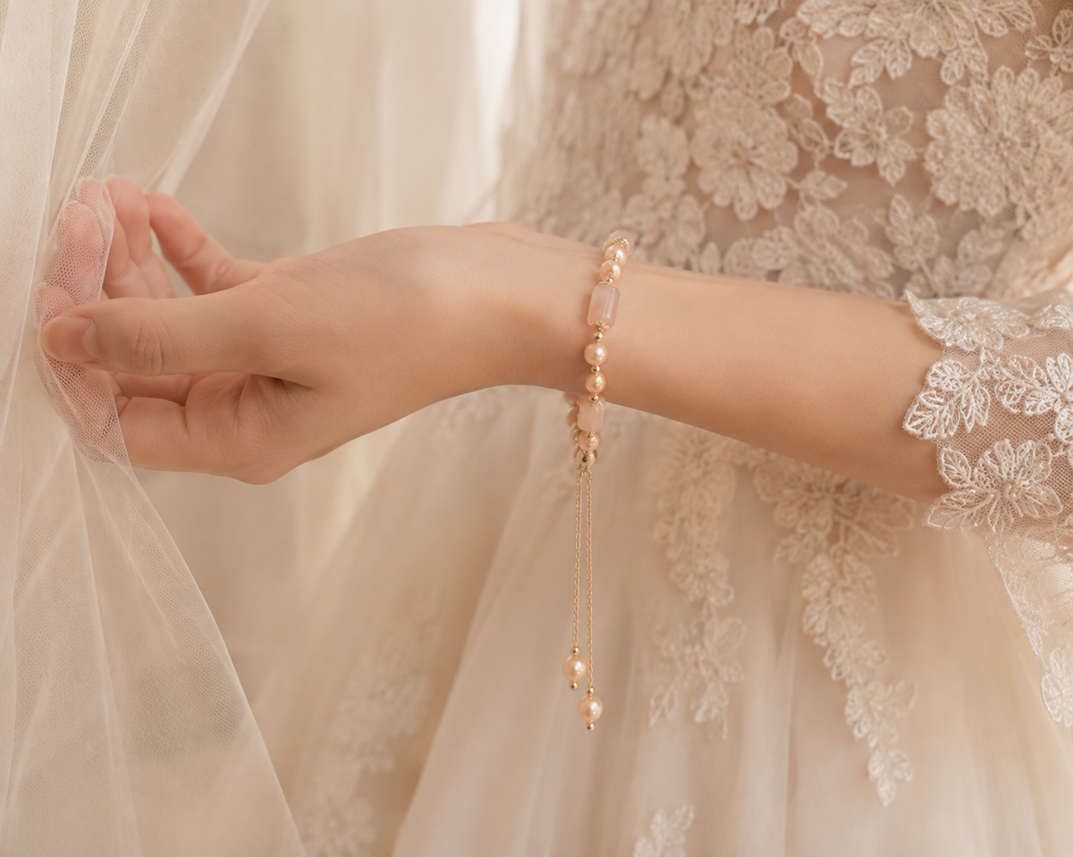 Bridal portrait featuring a champagne freshwater pearl bracelet with blush rectangular beads and dangling pearl drops