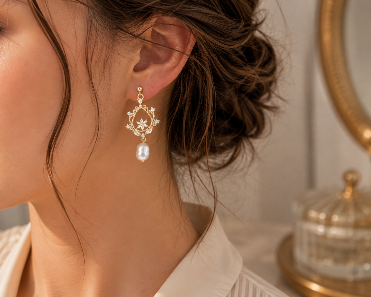Woman wearing freshwater pearl floral filigree drop earrings