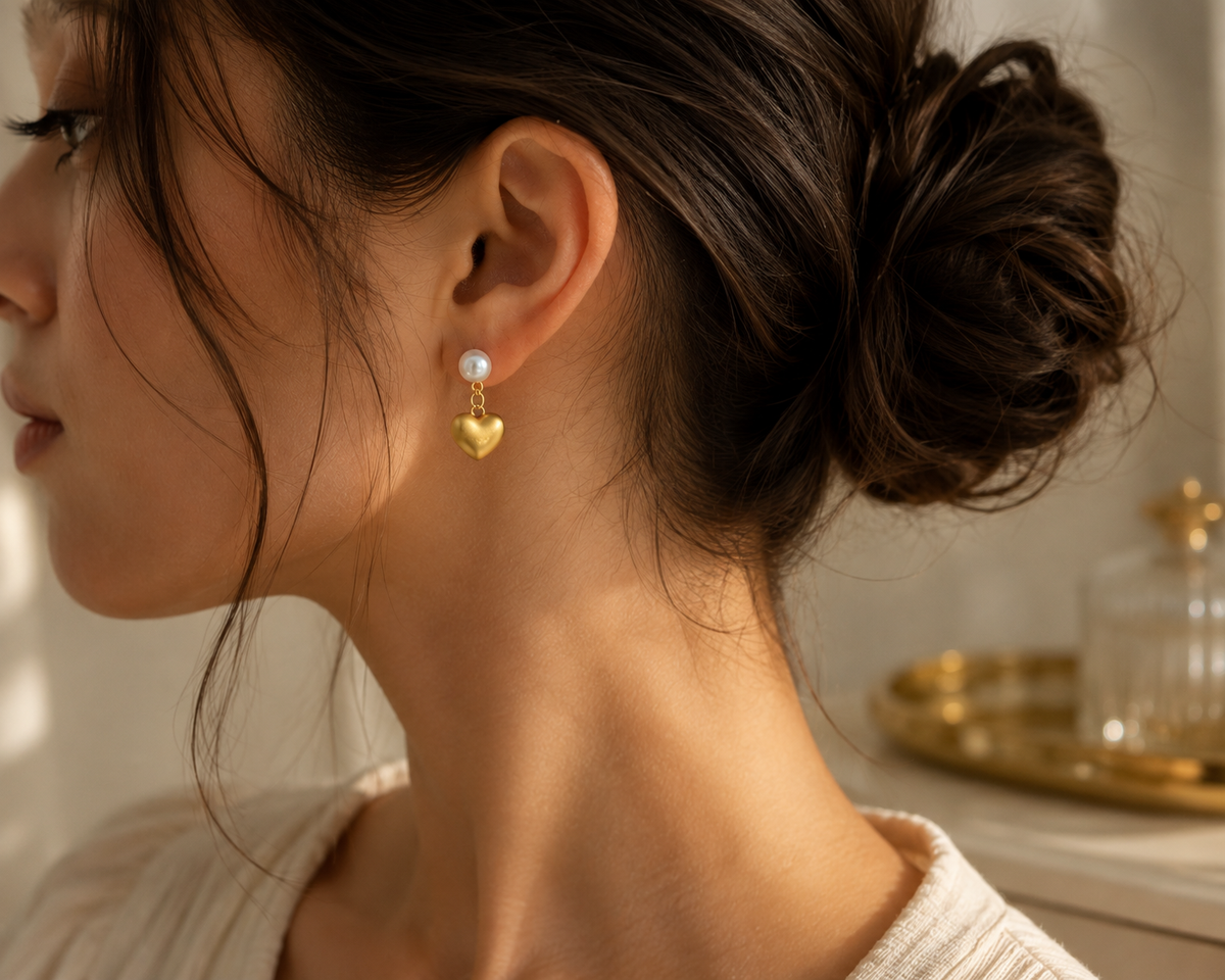 Woman wearing freshwater pearl heart drop earrings with an elegant updo