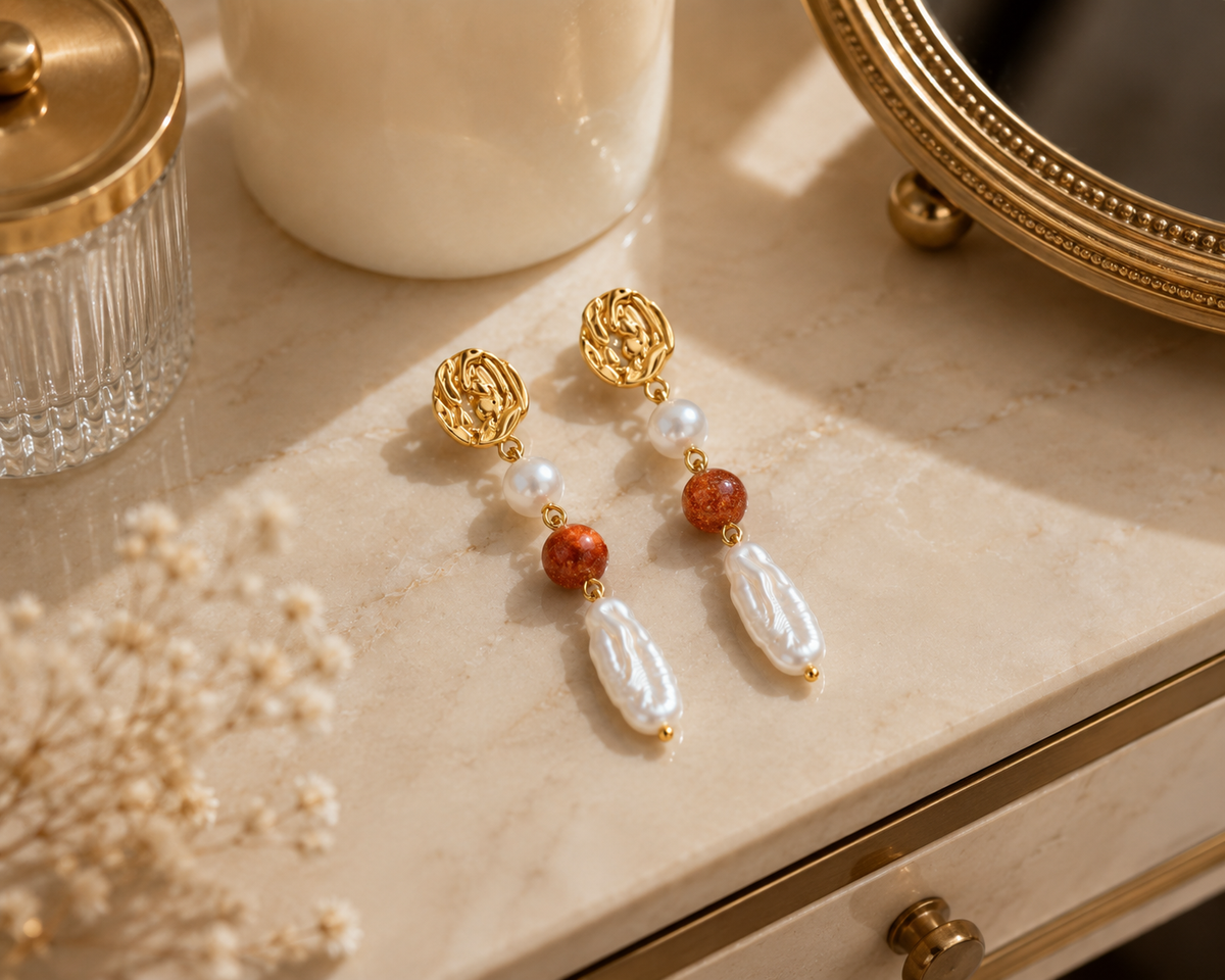 Pair of freshwater pearl long drop earrings displayed on a cream vanity