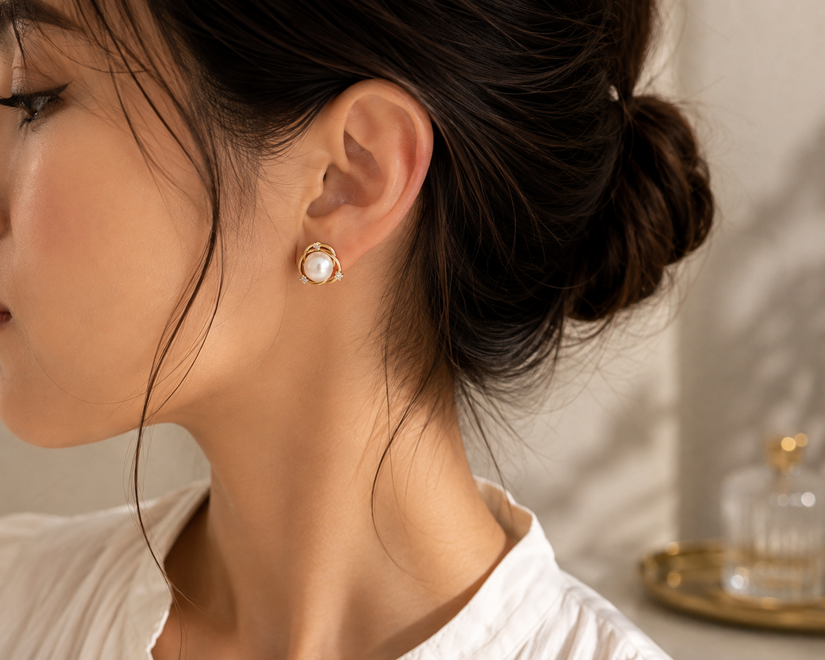 Woman wearing freshwater pearl orbit stud earrings from the left side
