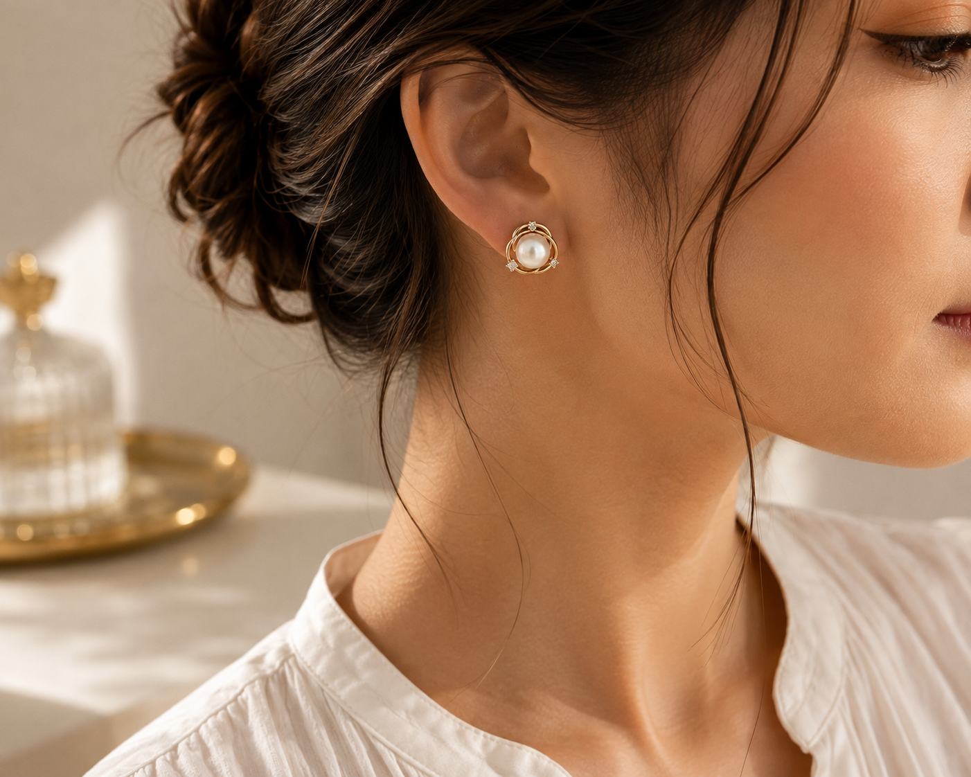 Woman wearing freshwater pearl orbit stud earrings from the right side