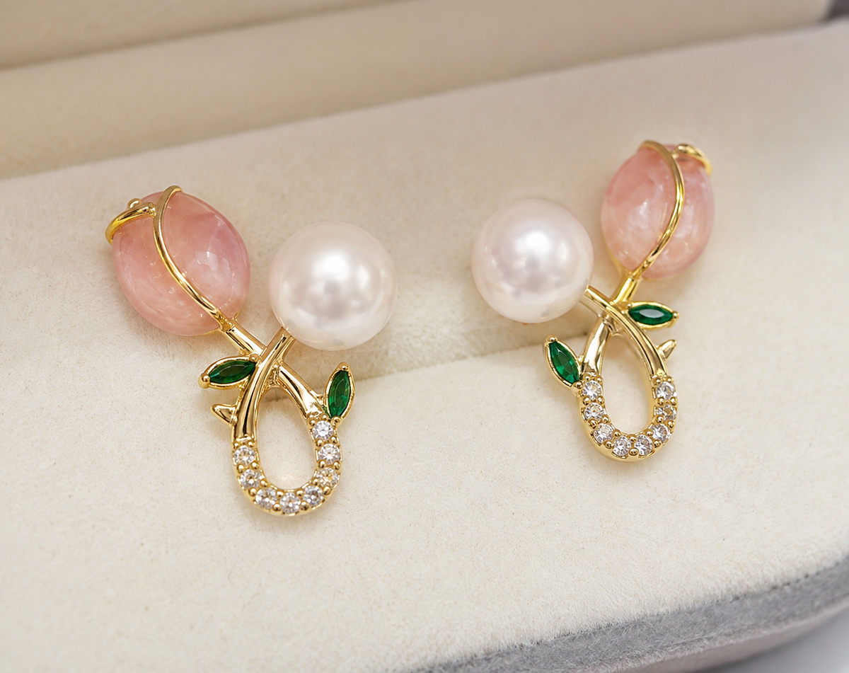 Pair of freshwater pearl floral stud earrings with pink stones and green leaves