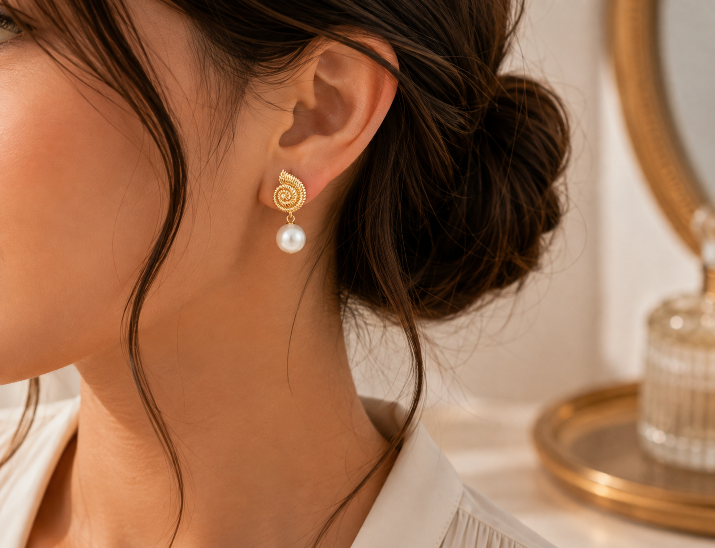Woman wearing freshwater pearl spiral drop earrings