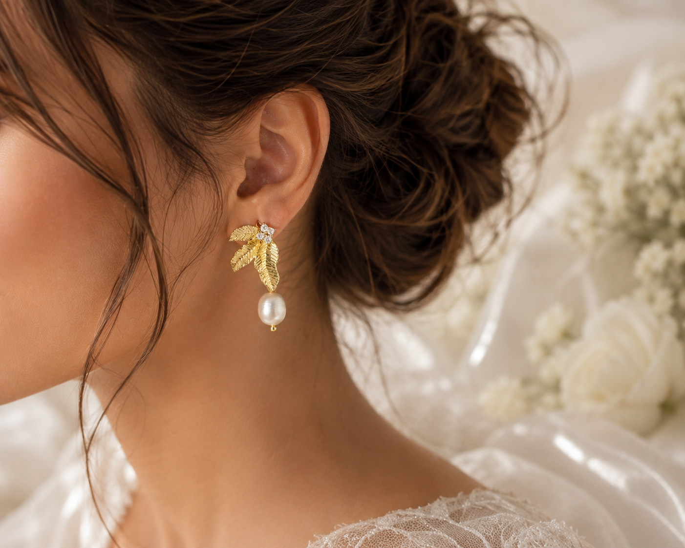 Bridal model wearing gold leaf and freshwater pearl dangle earrings