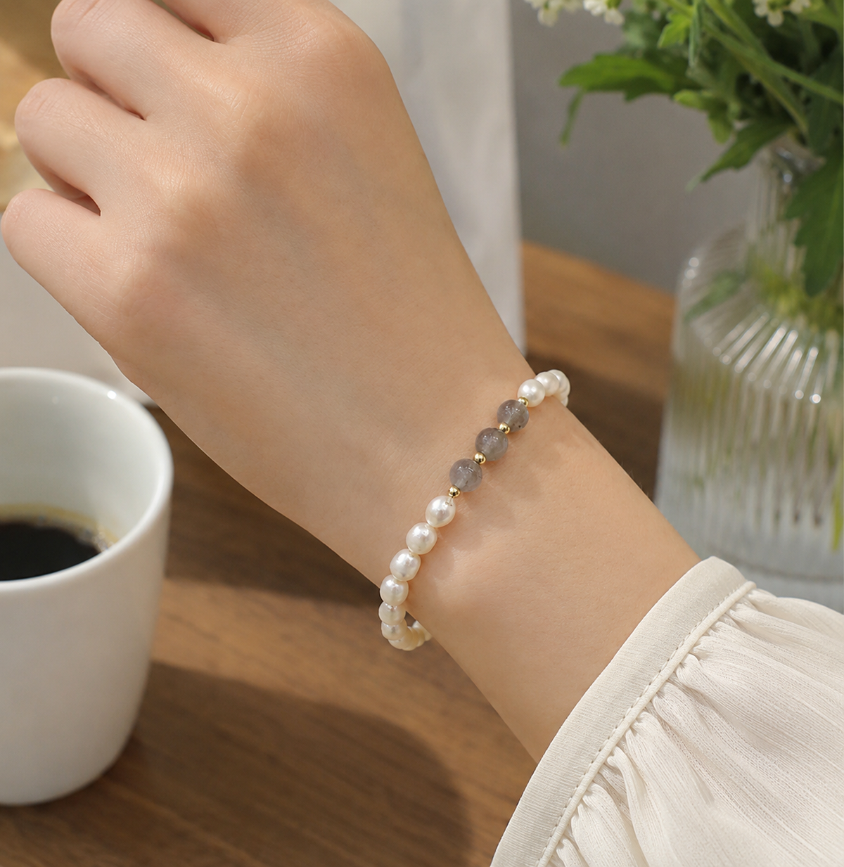 White pearl stretch bracelet with translucent gray beads and small gold-tone accents