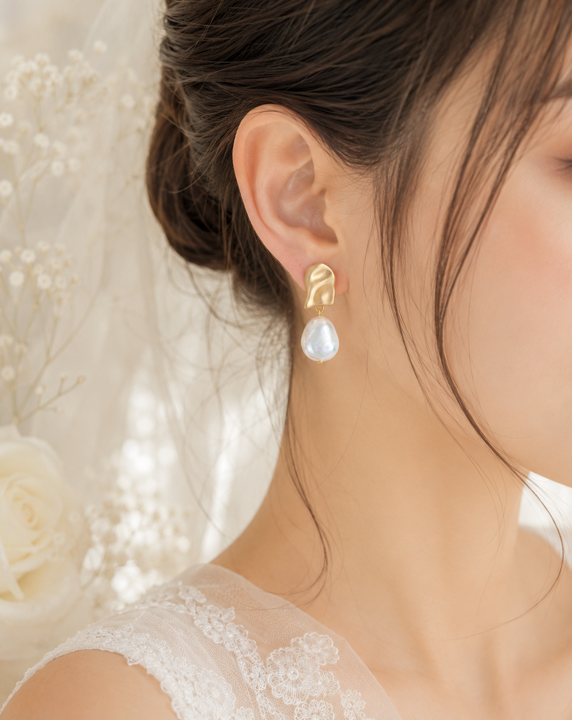 Bride wearing the large baroque pearl side with a sculptural matte gold-tone stud