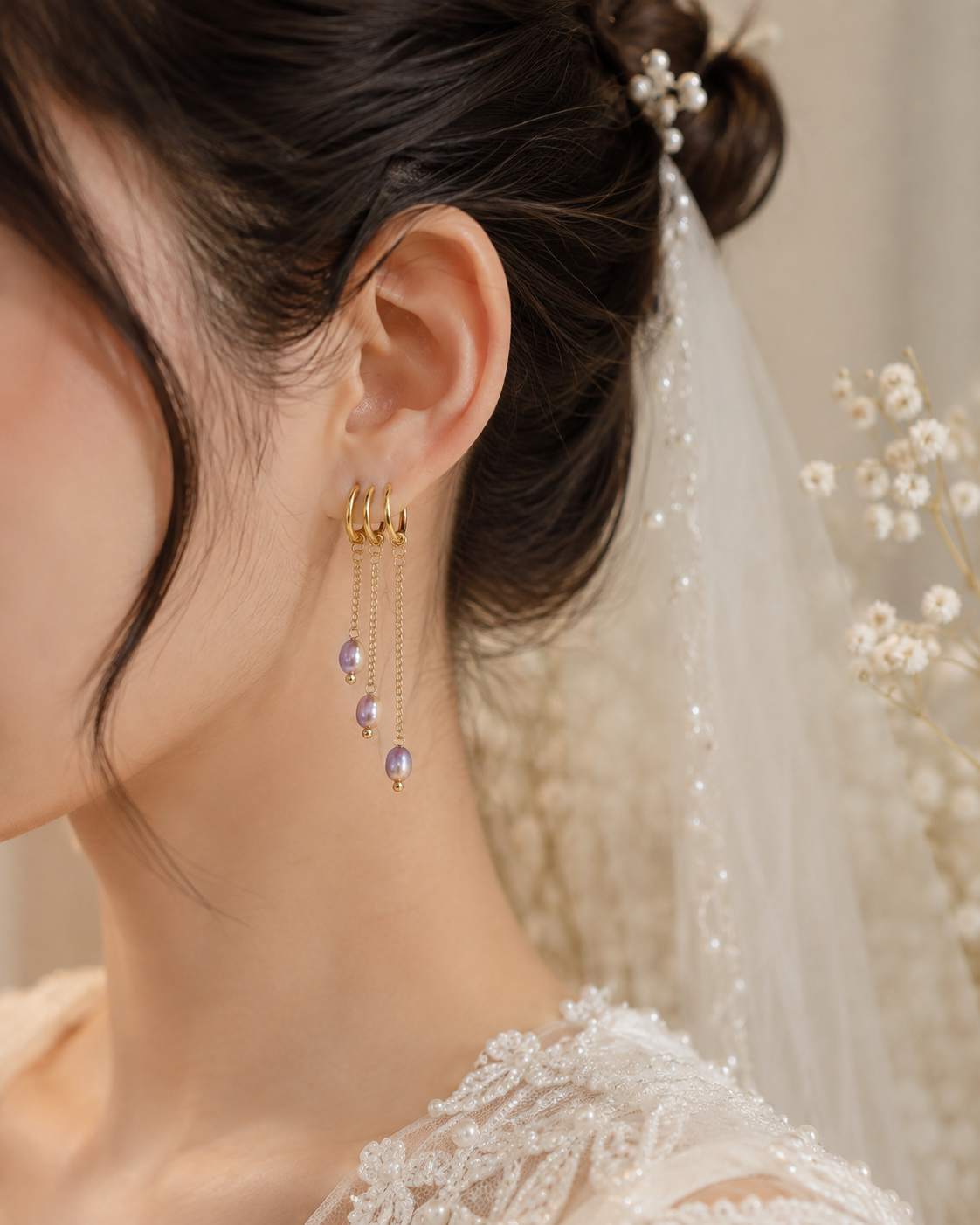 Bride wearing lavender freshwater pearl triple chain earrings with one piercing