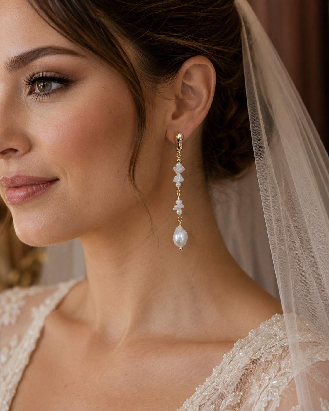 Bride wearing long gold-tone earrings with cascading freshwater pearls