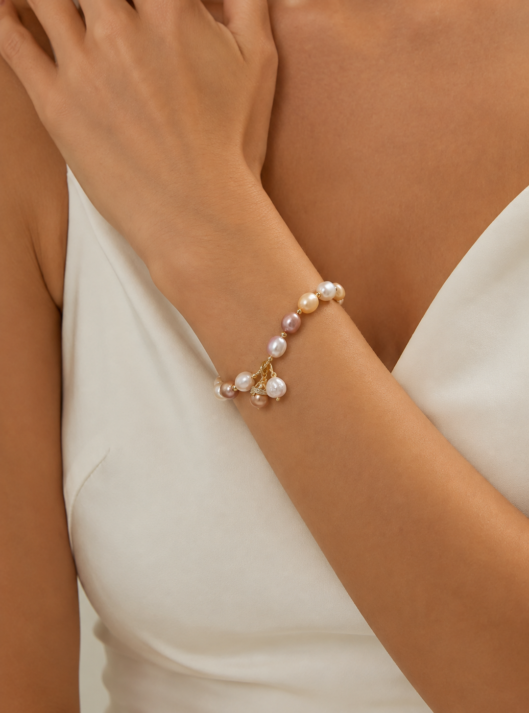 Bride wearing a multicolor freshwater pearl bracelet with gold-tone details