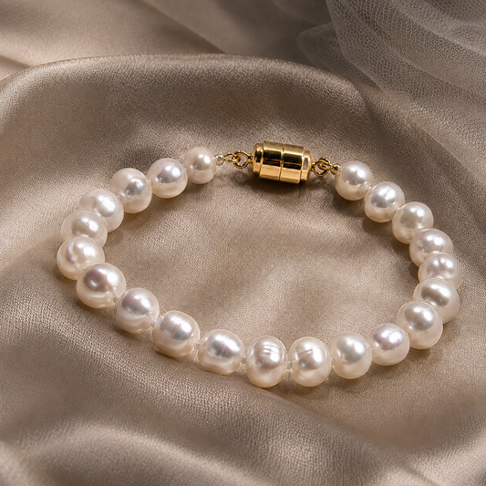 Natural freshwater pearl magnetic clasp bracelet displayed on champagne satin