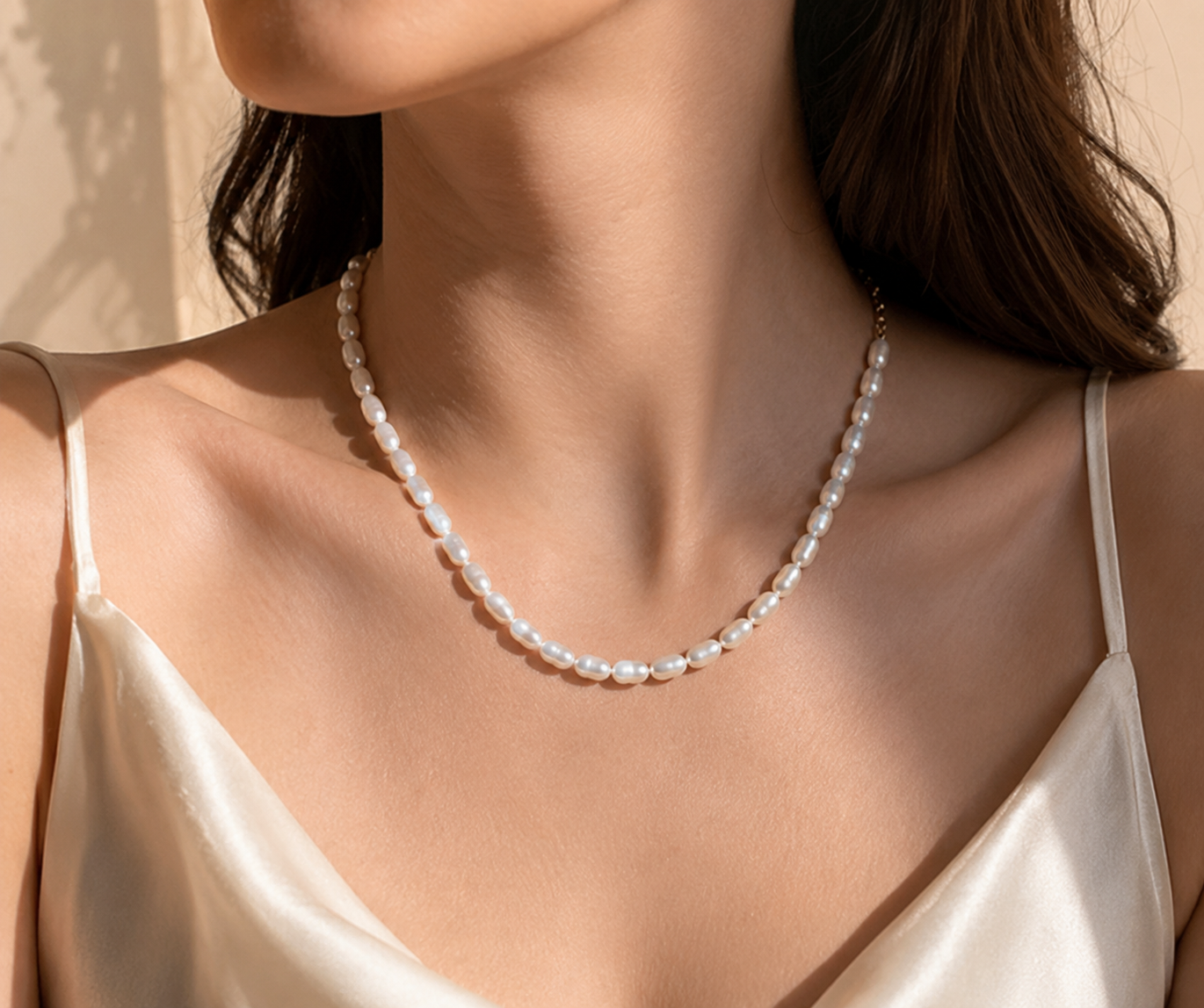 Front view of woman wearing a natural freshwater rice pearl necklace