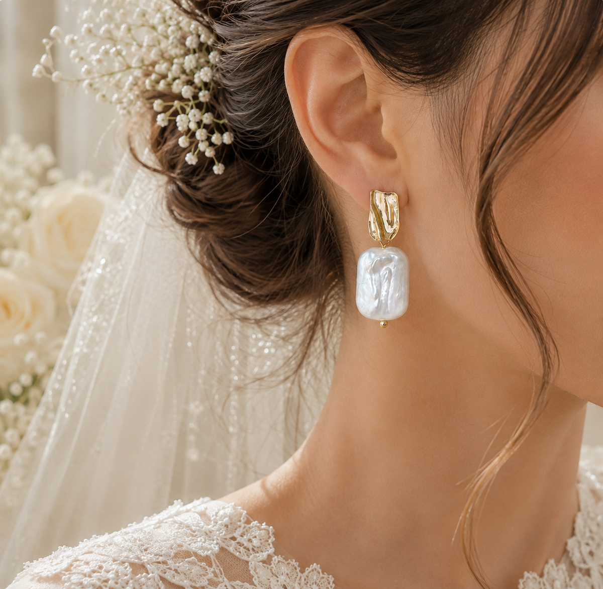 Wedding profile featuring an oversized white baroque pearl dangle earring