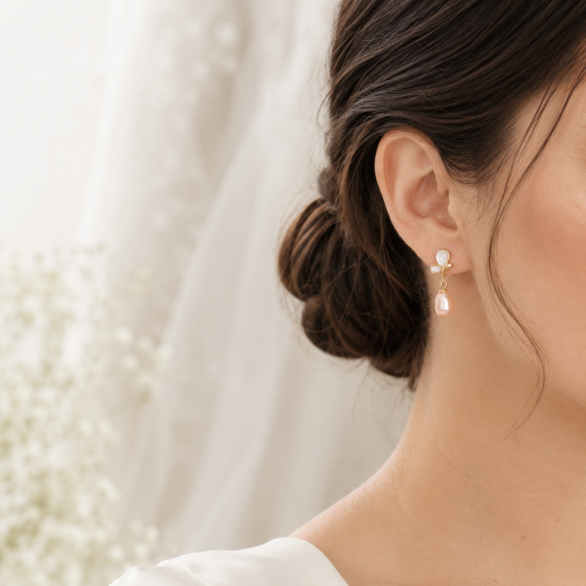 Bride wearing peach freshwater pearl butterfly dangle earrings