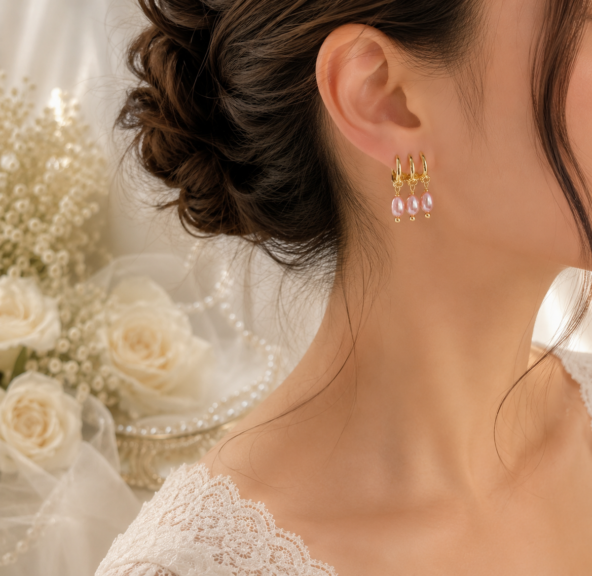 Side view of pink freshwater pearl triple hoop drop earrings worn with a bridal hairstyle