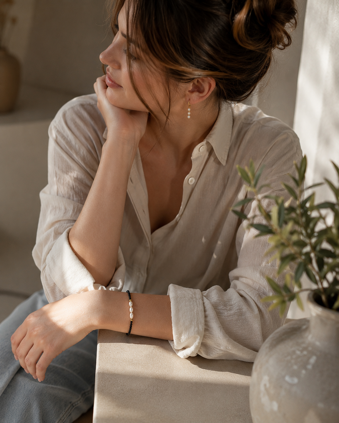 Three freshwater pearl bracelet with black beads and gold-tone accents styled for everyday wear