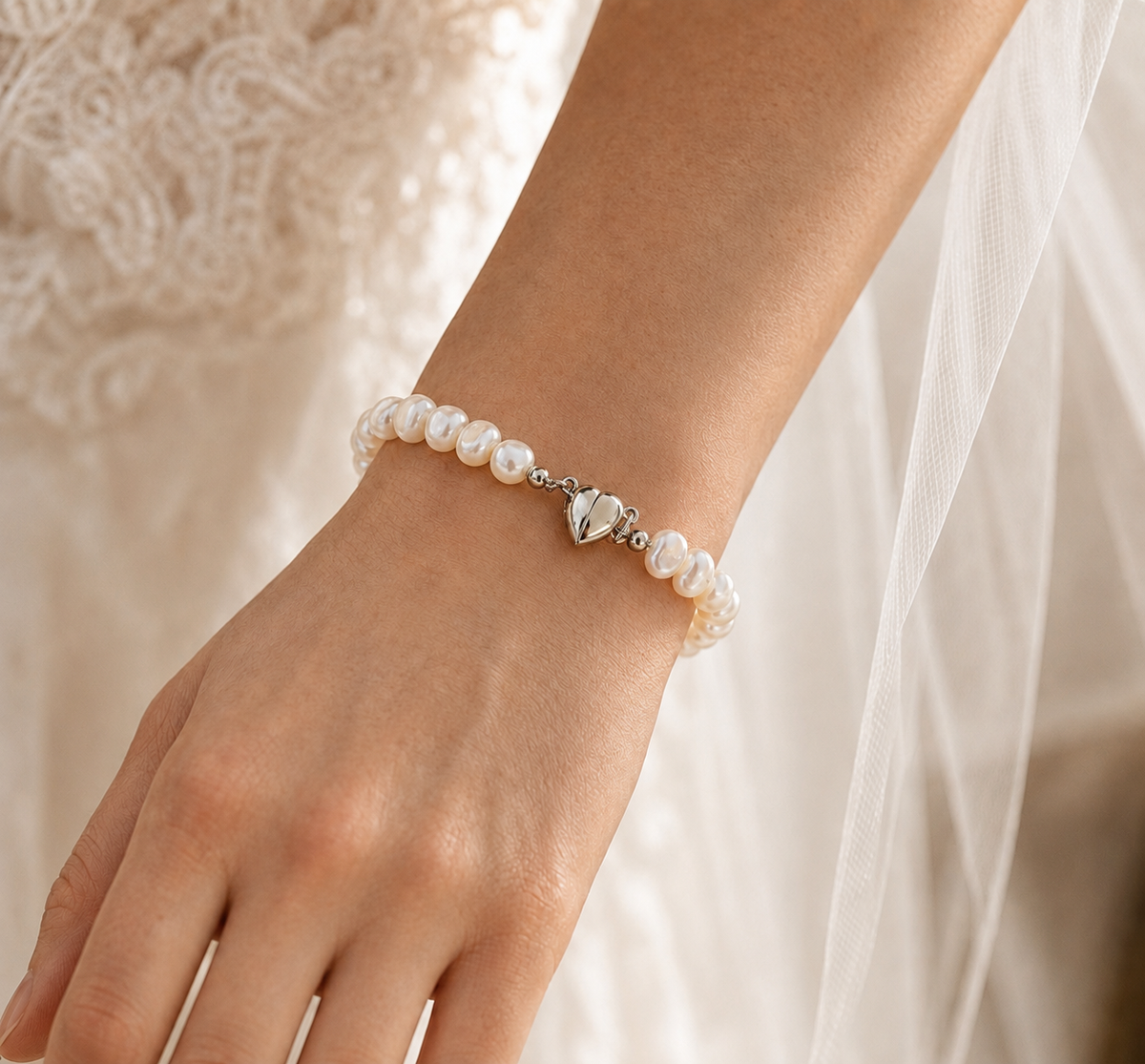 Bride wearing a white baroque freshwater pearl bracelet with a silver-tone heart clasp
